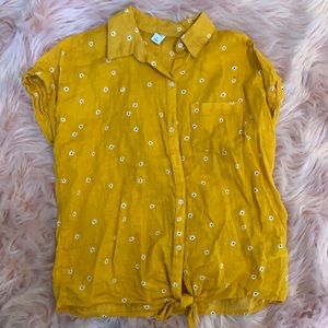 Yellow shirt with white flowers.